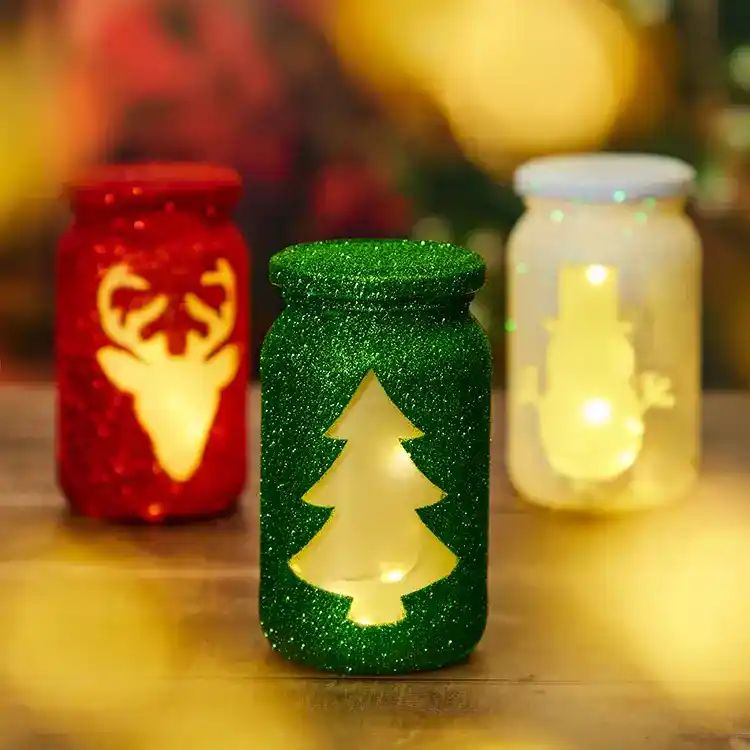 Glitter Christmas Tree, Deer, Snowman Cut Out Mason Jar Luminaries. Christmas Candles in Mason Jars. Mason Jar Candle Ideas for Holidays. Easy Christmas Candle DIY Ideas. How to Make a Holiday Candle with Mason Jars. Mason Jar Crafts for Kids for Christmas. Winter Crafts with Mason Jars. Mason Jar Luminaries for the Holidays. Decorating for the Holidays with Mason Jars.