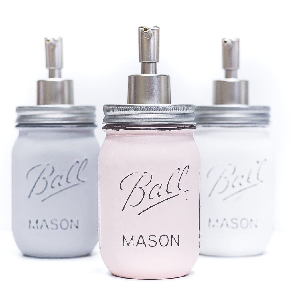 DIY mason jar bathroom soap and lotion dispensers. Chalk painted and distressed mason jar soap dispensers. Mason Jar Bathroom Storage and Organization Ideas. Organizing the bathroom with mason jars. Pretty storage ideas with mason jars. Rustic storage ideas with mason jars. Bathroom storage using mason jars.