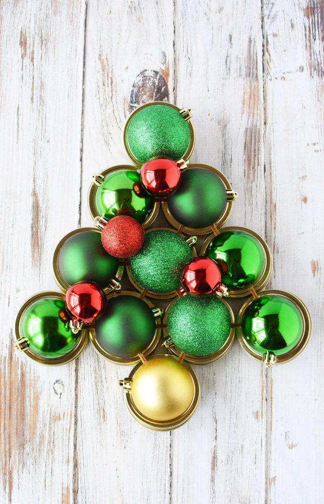 Mason Jar Lid Christmas Tree with Green and Red Christmas Balls. Unique Christmas Crafts with Mason Jars and Lids. Mason Jar Holiday Craft Ideas. Mason Jar Lid Winter Craft Ideas. Mason Jar Lid Wreaths. Mason Jar Lid Snowman.