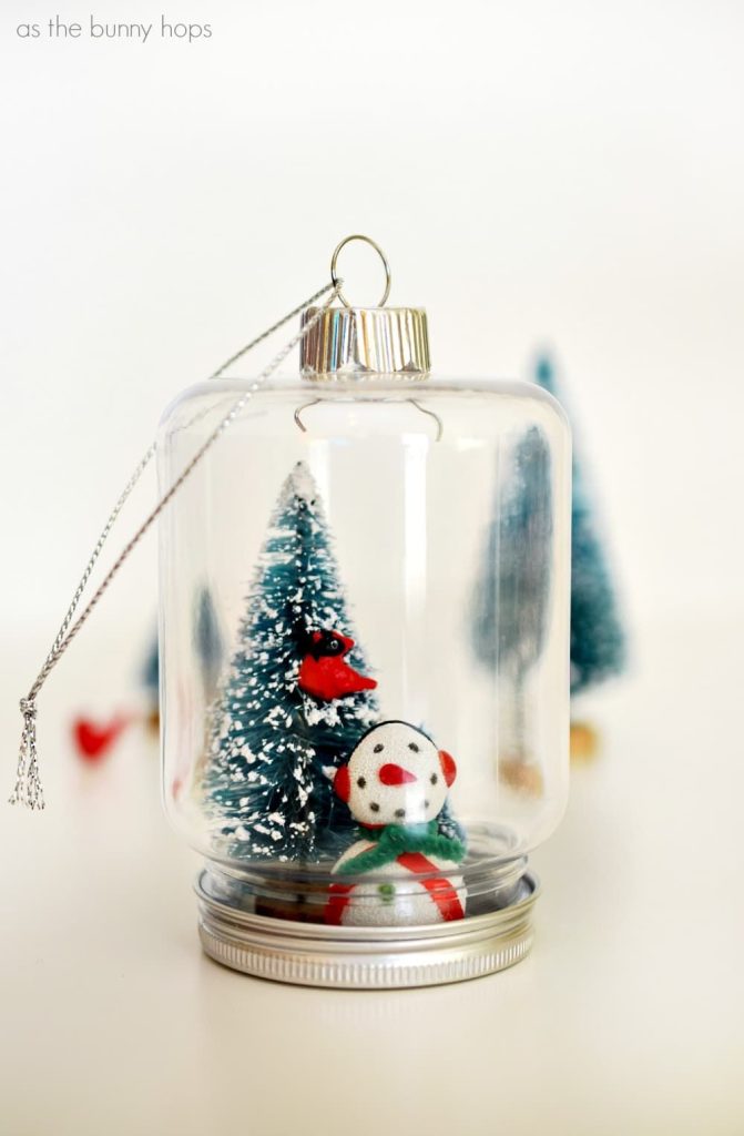 Mason Jar Snow Globe with Bottle Brush Tree and Snowman Ornament DIY. Mason Jar Christmas Ornament Craft Ideas. DIY Mason Jar Ornaments - Christmas Crafts with Mason Jars - Homemade Ornament Craft Ideas. Mini Mason Jar Ornaments tutorial. Mason Jar Lid Ornaments. Mason Jar Lid Mini Wreath Ornaments.
