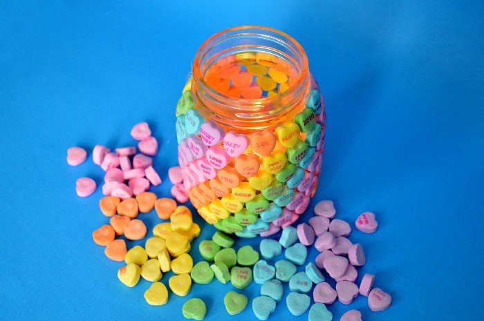 Conversation Hearts Glued to Mason Jar Votive Ideas. Valentine Mason Jar Crafts. Mason Jar Valentine's Day Craft Ideas. Gift Ideas in Mason Jars for Valentine's Day. 55+ Valentine Jar Crafts & More