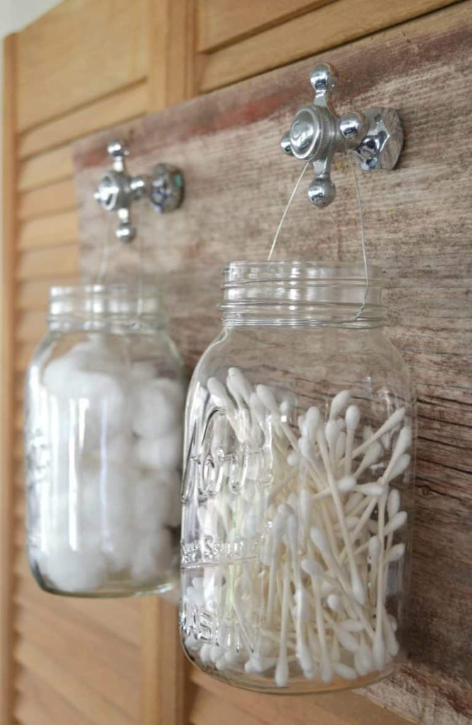 Rustic mason jar hanging storage ideas for bathroom. Mason Jar Bathroom Storage and Organization Ideas. Organizing the bathroom with mason jars. Pretty storage ideas with mason jars. Rustic storage ideas with mason jars. Bathroom storage using mason jars.