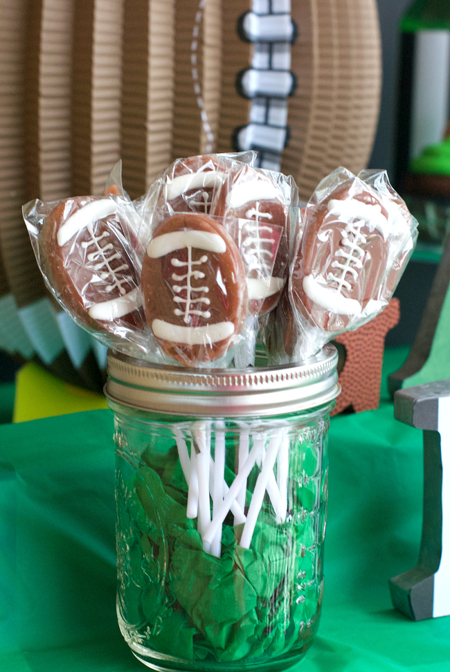 Football Mason Jar Crafts & Party Ideas. Football Party with Mason Jars. Mason Jar Football Centerpiece. Mason jar football drink cups. Mason jar football utensil holder.