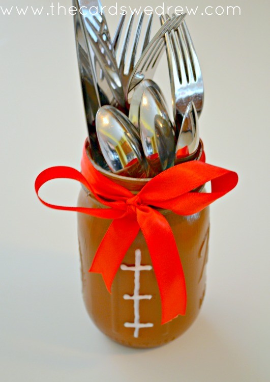 Football Mason Jar Utensil Holder. Football Mason Jar Crafts & Party Ideas. Football Party with Mason Jars. Mason Jar Football Centerpiece. Mason jar football drink cups. Mason jar football utensil holder.