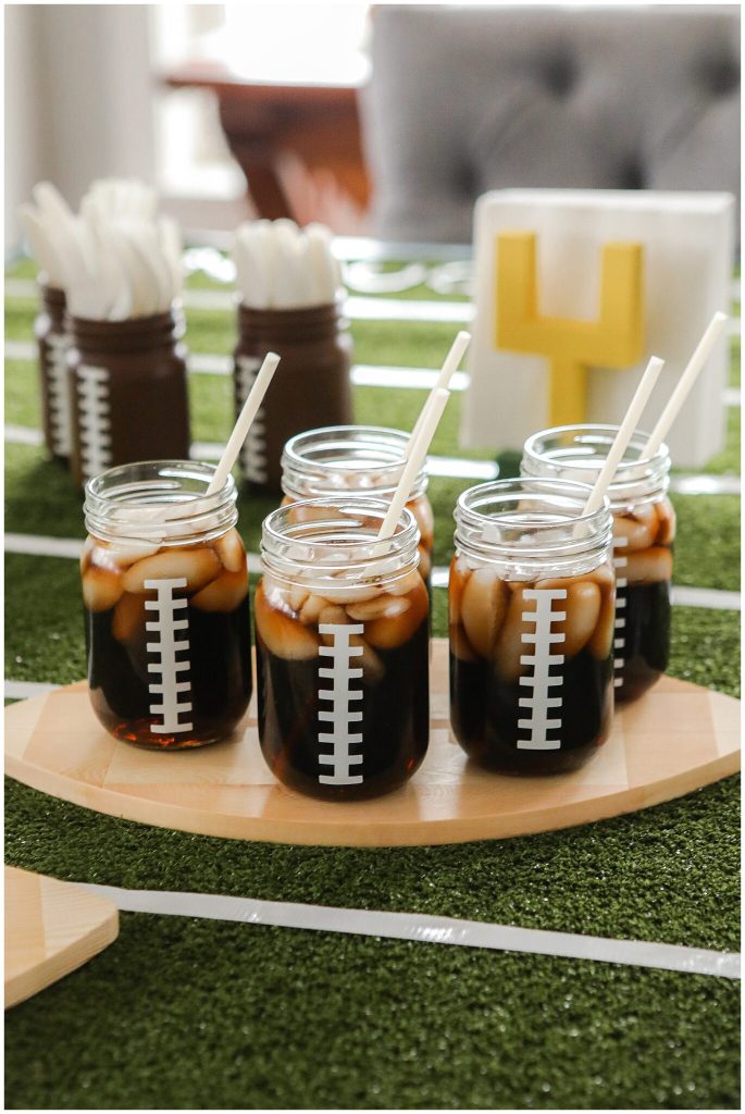 Football Mason Jar Crafts & Party Ideas. Football Party with Mason Jars. Mason Jar Football Centerpiece. Mason jar football drink cups. Mason jar football utensil holder.