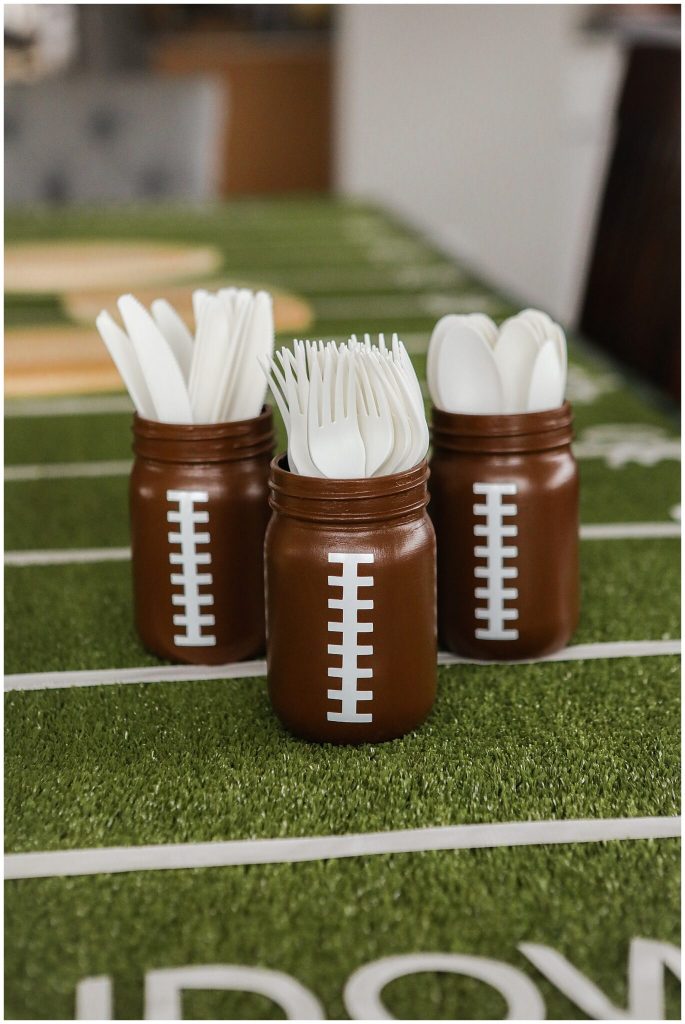 Football Mason Jar Crafts & Party Ideas. Football Party with Mason Jars. Mason Jar Football Centerpiece. Mason jar football drink cups. Mason jar football utensil holder.