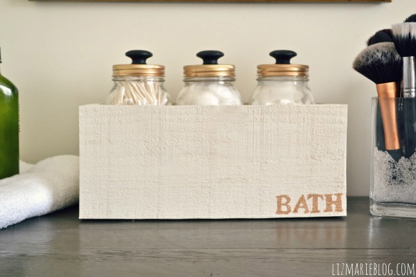 Mason Jar Cotton Ball Storage with Custom Box for Bathroom Countertop. Mason Jar Bathroom Storage and Organization Ideas. Organizing the bathroom with mason jars. Pretty storage ideas with mason jars. Rustic storage ideas with mason jars. Bathroom storage using mason jars.