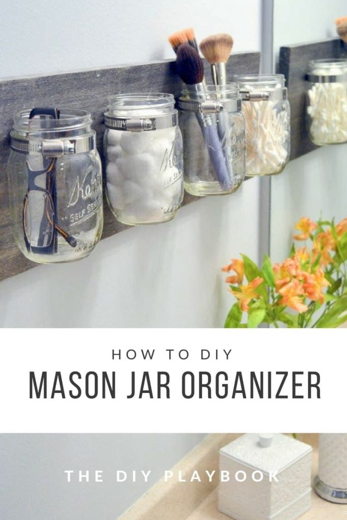 Mason Jar Wall Mounted Bathroom Organizer. Reclaimed Wood Bathroom Organization with Mason Jars. Mason Jar Bathroom Storage and Organization Ideas. Organizing the bathroom with mason jars. Pretty storage ideas with mason jars. Rustic storage ideas with mason jars. Bathroom storage using mason jars.