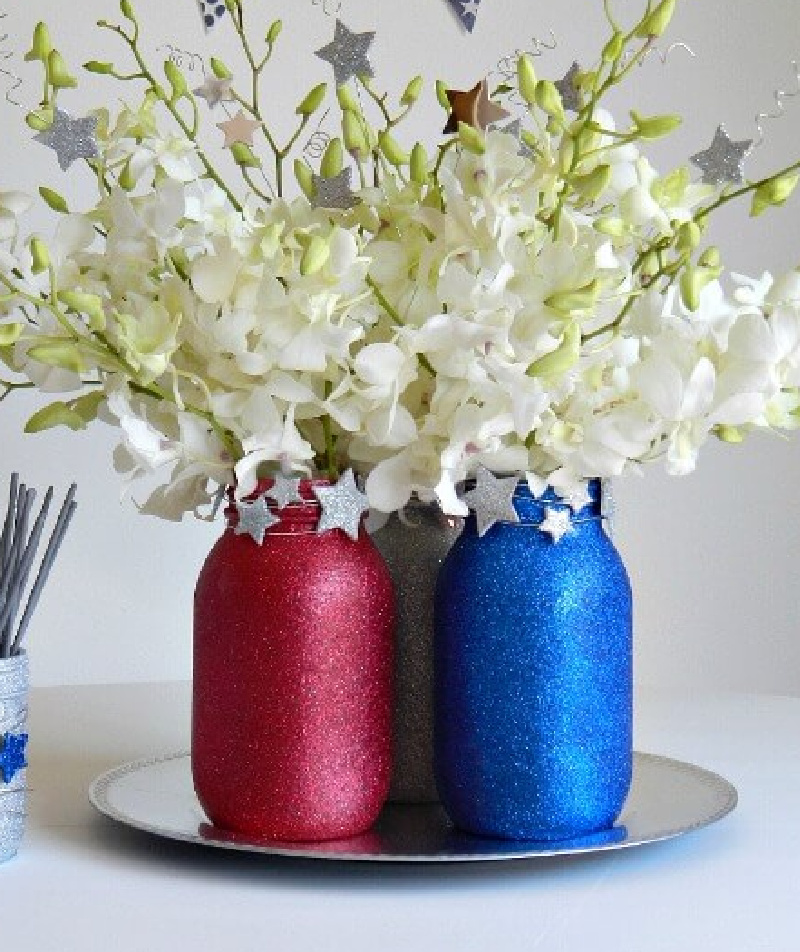 Fourth of July Mason Jar Crafts and Decor Ideas. Red, White and Blue Mason Jars. Patriotic Mason Jars. Semiquincentennial Mason Jars to Celebrate 4th of July. July 4 Decor Ideas with Mason Jars. Mason Jar Kid's Crafts for July 4th.