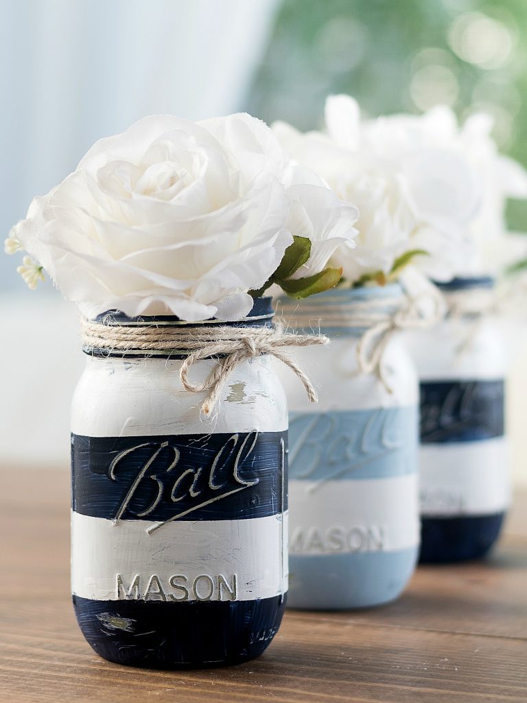 Nautical Mason Jars. Nautical Blue and White Striped Mason Jars. Painted Mason Jars with Stripes and Twine. Summer Mason Jar Crafts. Kid's Craft for Summer with Mason Jars. Coastal Mason Jar Ideas. Painted Mason Jars for Summer. Mason Jar Planters. Twine Wrapped Mason Jar Crafts. Firefly Mason Jars. Mason Jar Votives for Summer.