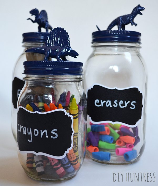 Dinosaur Topped School Supply Mason Jar Holders. Mason Jar Craft Ideas for Back to School, Teacher Gift Mason Jars - Mason Jar Gift Ideas for Teachers - School Themed Mason Jars. Mason Jar Pencil Holders Themed for School, Students, Teachers. Back to School Teacher Gift Ideas. Holiday Teacher Gift Ideas with Mason Jars. DIY Teacher Gift Ideas.